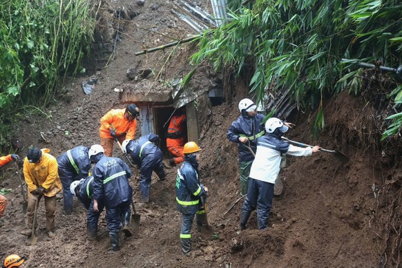 Rescuers coduct search and rescue operations for missing residents a day after several houses were buried from a landslide in Guisad Surong, Baguio City, northern Philippines, Monday, Aug. 10, 2026. ( ...