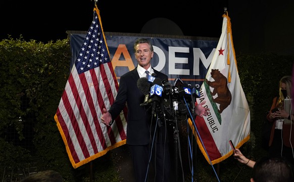 California Gov. Gavin Newsom addresses reporters after beating back the recall attempt that aimed to remove him from office, at the John L. Burton California Democratic Party headquarters in Sacrament ...