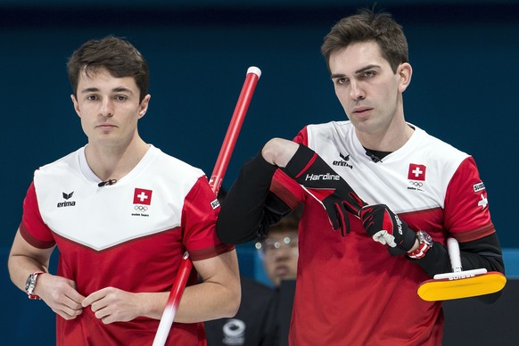 Benoit Schwarz and Peter de Cruz of Switzerland, from left, during the Curling round robin game of the men between Switzerland and Great Britain at the XXIII Winter Olympics 2018 in Gangneung, South K ...