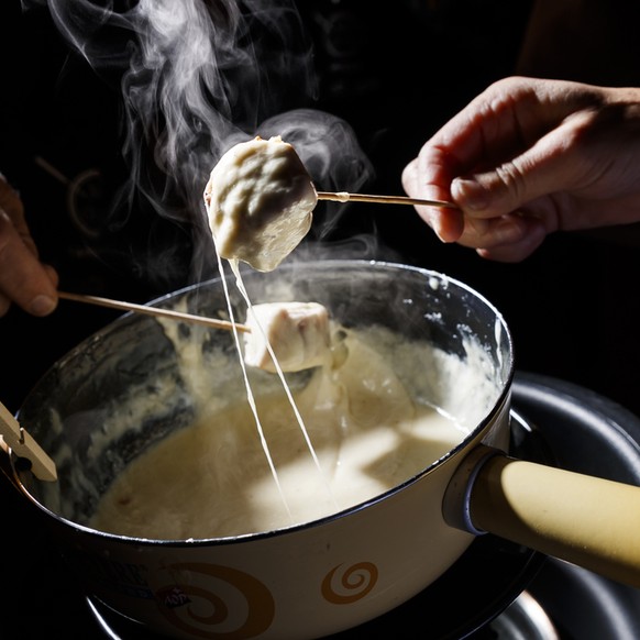 Jury members stir and taste a cheese fondue during the first qualifying round of the second World Cheese Fondue competition in Tartegnin, Switzerland, Saturday November 18 2017. The event aims to rewa ...