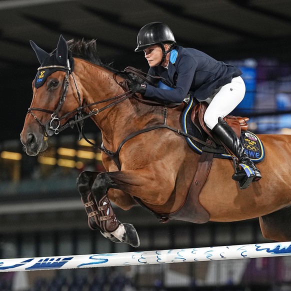 epa09403397 Malin Baryard-Johnsson of Sweden on Indiana competes in the Jumping team final during the Equestrian events of the Tokyo 2020 Olympic Games at the Baji Koen Equestrian Park in Setagaya, To ...