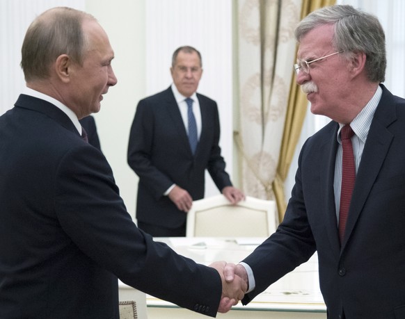 epa06844003 Russian President Vladimir Putin (L) shakes hands with US National security advisor John Bolton (R) during their meeting in the Kremlin in Moscow, Russia, 27 June 2018. US President Donald ...