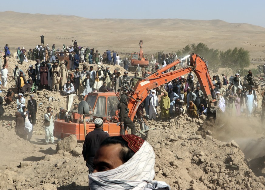 An excavator removes mud from a collapsed house and searches victims after an earthquake in Zenda Jan district in Herat province, of western Afghanistan, Sunday, Oct. 8, 2023. Powerful earthquakes kil ...