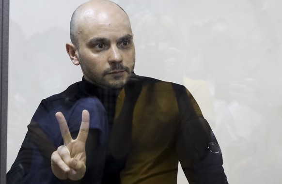 Andrei Pivovarov, the head of Open Russia movement gestures standing behind the glass during a court session in Krasnodar, Russia, Wednesday, June 2, 2021. In the southern city of Krasnodar, a court w ...