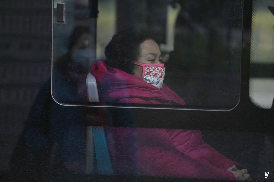 epa08143672 Chinese residents wear masks in a bus near the closed Huanan Seafood Wholesale Market, which has been linked to cases of a new strain of Coronavirus identified as the cause of the pneumoni ...