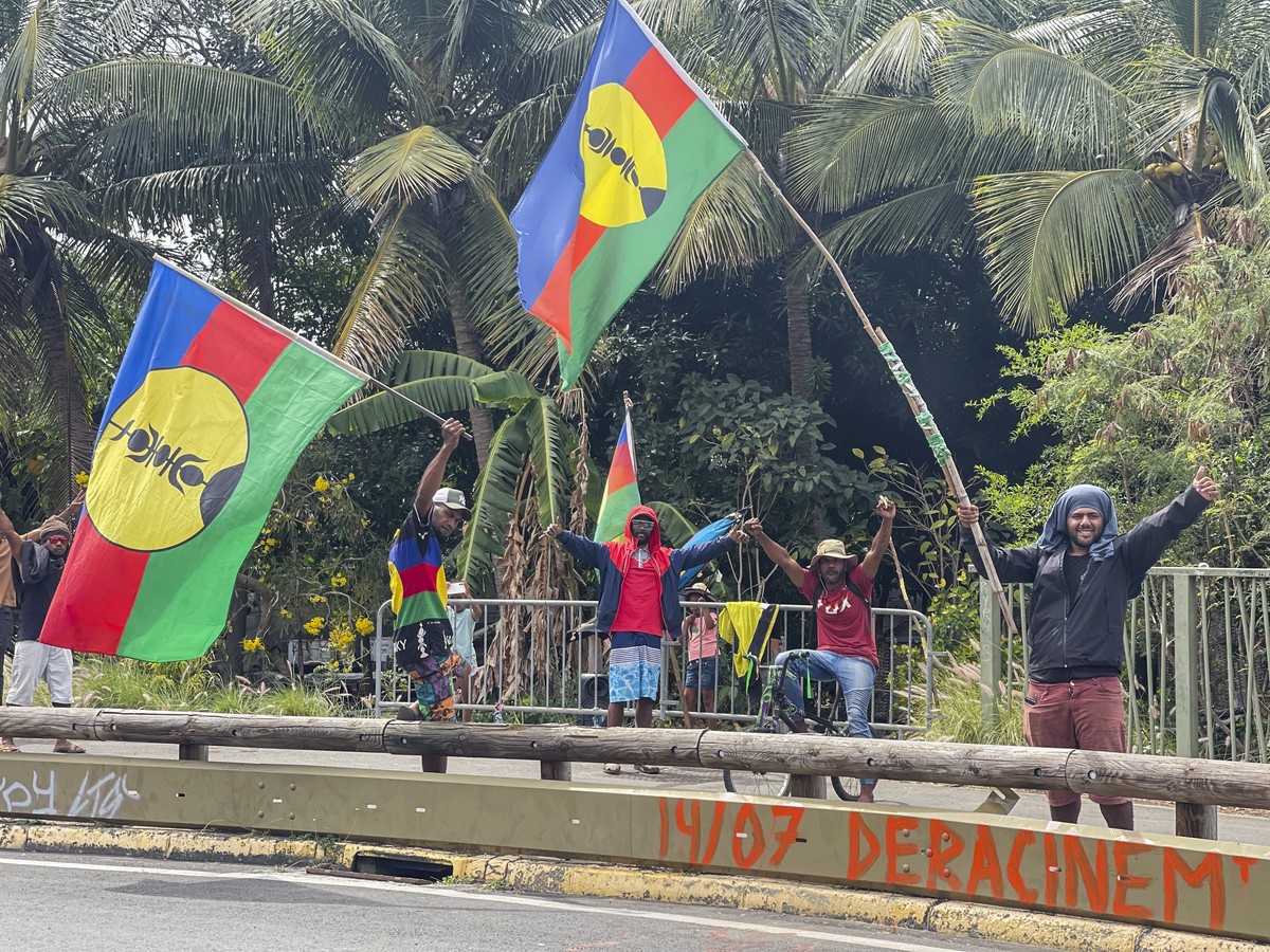 Indigenous Kanaks wave independent flags during the 171th anniversary of France's takeover of the Pacific Archipelago, in Noumea, New Caledonia, French Pacific islands, Tuesday Sept. 24, 2024. (A ...