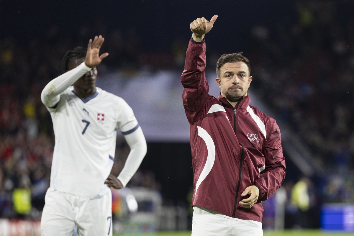 Switzerland's Xherdan Shaqiri, right, and Switzerland's Breel Embolo, left, react after the draw (1-1) during a Group A match between Scotland and Switzerland at the Euro 2024 soccer tournam ...