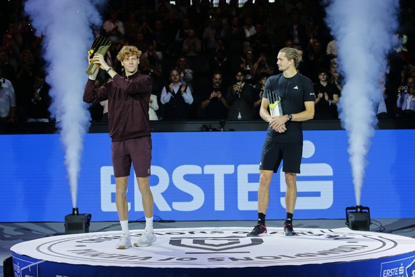 Jannik Sinner of Italy, left, displays the trophy after winning the final match against Germany&#039;s Alexander Zverev, right, at the ATP tennis tournament in Vienna, Austria,Sunday, Oct. 26, 2025. ( ...