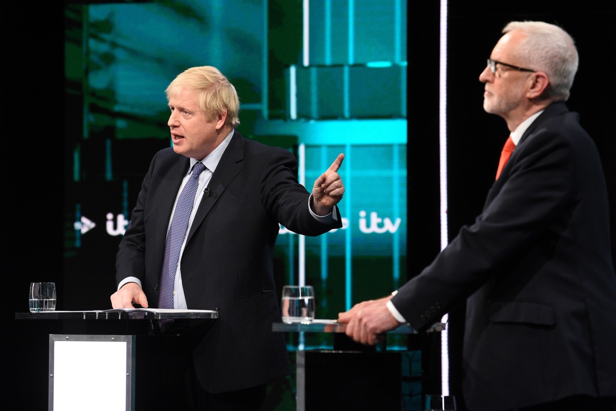 epa08009955 A handout photo made available by ITV shows British Prime Minister and Conservative Party leader Boris Johnson (L) and Labour Party leader Jeremy Corbyn (R) during live debate 'Johnso ...