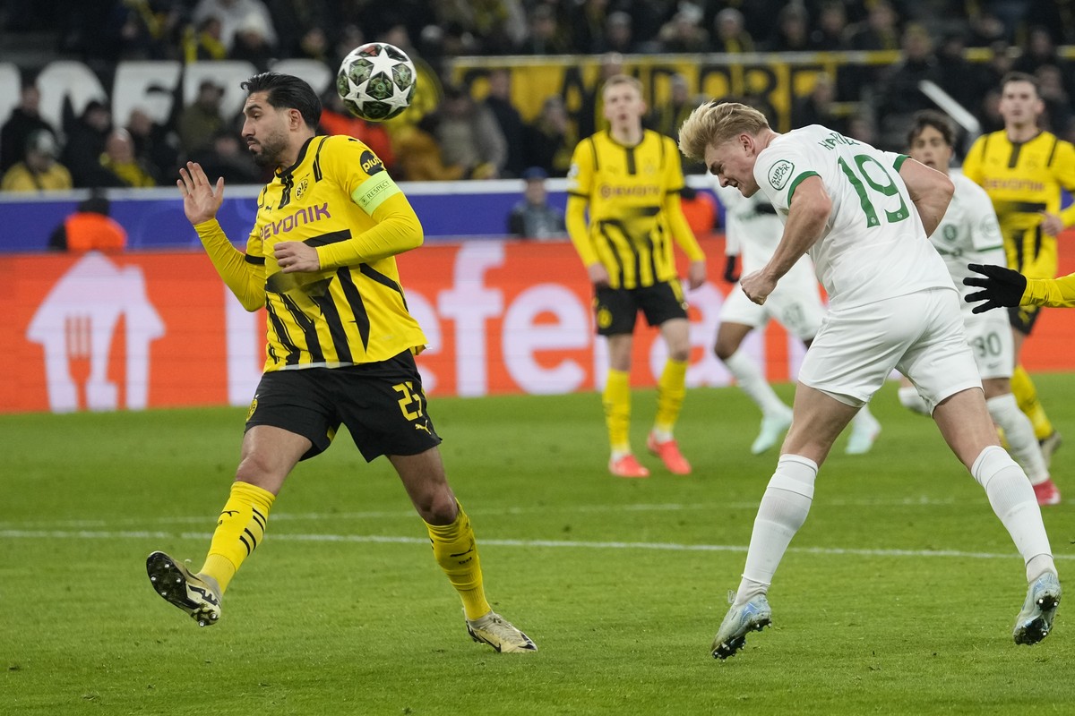Sporting's Conrad Harder heads the ball by Dortmund's Emre Can during the Champions League playoff second leg soccer match between Borussia Dortmund and Sporting CP at the Signa-Iduna Park i ...