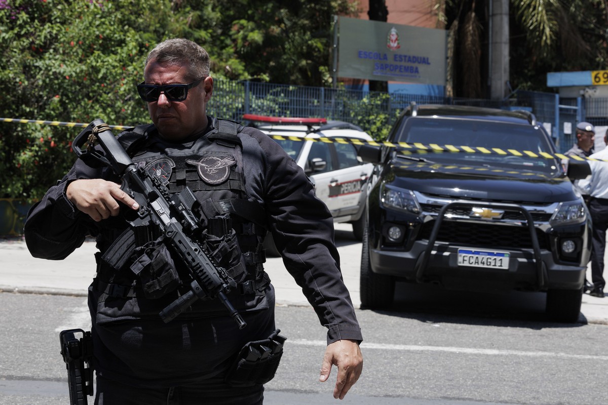 epa10934545 Police officers control the entrance to a public school where a shooting occurred in Sao Paulo, Brazil, 23 October 2023. According to police reports, three persons were injured during the  ...