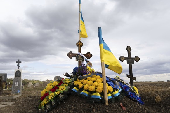 The grave of Ukrainian soldier Andrii Kozyr, who was reburied the day before, in the village of Hroza near Kharkiv, Ukraine, Friday, Oct. 6, 2023. The Russian rocket hit a cafe where friends and relat ...