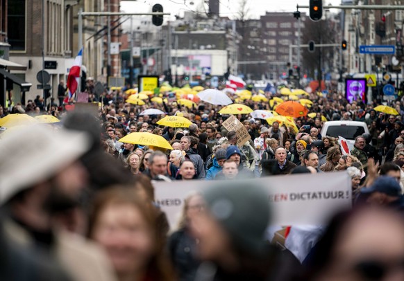 epa09085636 Protesters march during a protest within the scope of &#039;World Wide Rally for Freedom and Democracy&#039; on the Museumplein in Amsterdam, the Netherlands, 20 March 2021. Some 250 demon ...