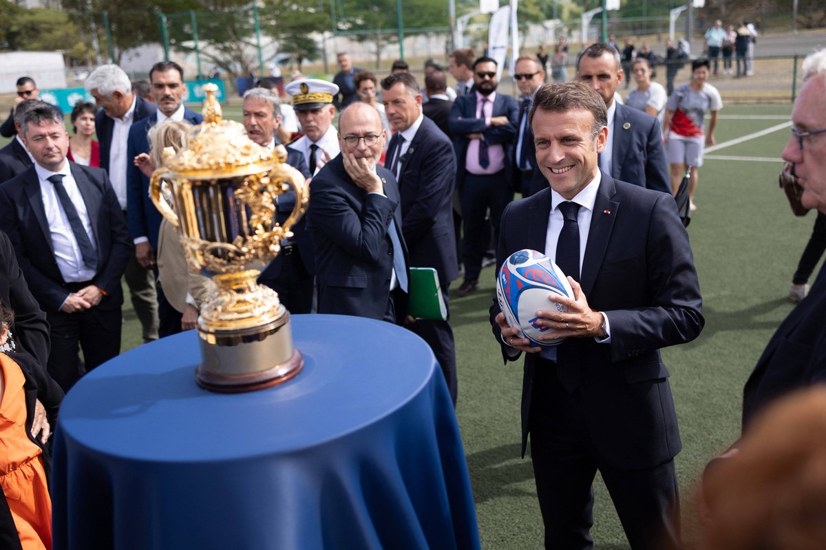 President Macron Meets Visits The Magenta Area - Noumea French President Emmanuel Macron looks at the Webb Ellis Cup trophy of the 2023 Rugby World Cup as he visits the Magenta Sports Arena in Noumea, ...