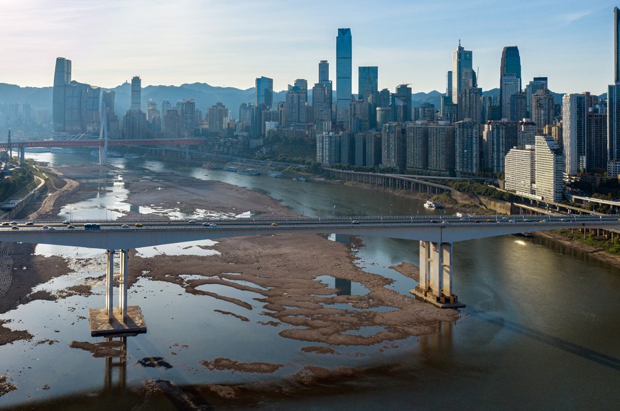 epa10131504 An aerial shot taken with a drone shows the dried out riverbed of the Jialing River, a major tributary of the Yangtze River, in Chongqing, China, 21 August 2022. China is experiencing its ...