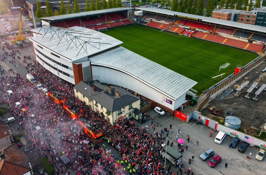 Wrexham Victory Parade An aerial view of open topped busses carrying Wrexham players passes the Racecourse Ground, home of Wrexham, during a victory parade in Wrexham, Wales. Picture date: Tuesday May ...