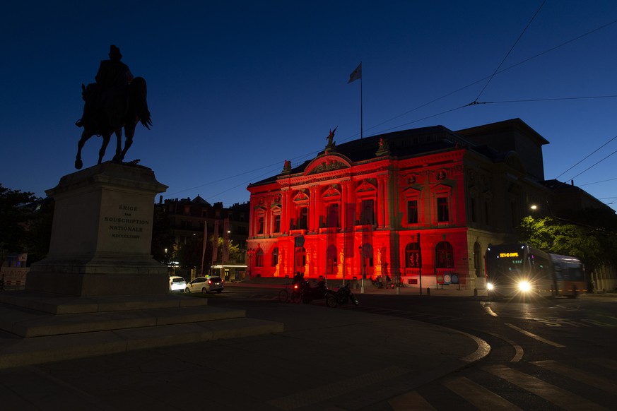 epa08502839 The Grand Theatre de Geneve (Opera house of Geneva) is illuminated in red to mark the dramatic situation in the event industry due to the coronavirus COVID-19 pandemia, during the 'Ni ...