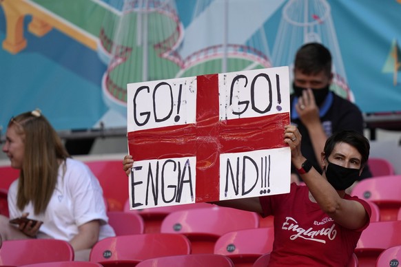 An England supporter holds up a poster during the players warmup before the Euro 2020 soccer championship group D match between England and Croatia at Wembley stadium in London, Sunday, June 13, 2021. ...