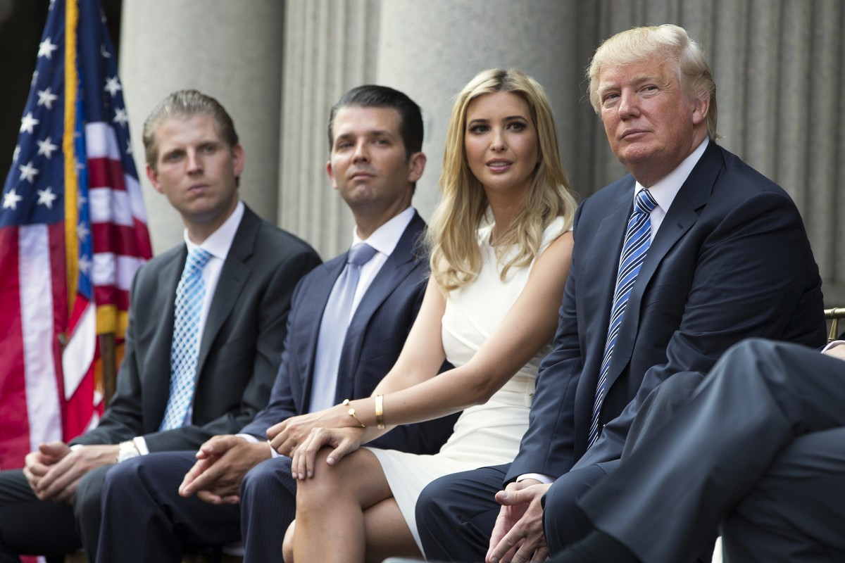 FILE - In this July 23, 2014 file photo, Donald Trump, right, sits with his children, from left, Eric Trump, Donald Trump Jr., and Ivanka Trump during a ground breaking ceremony for the Trump Internat ...