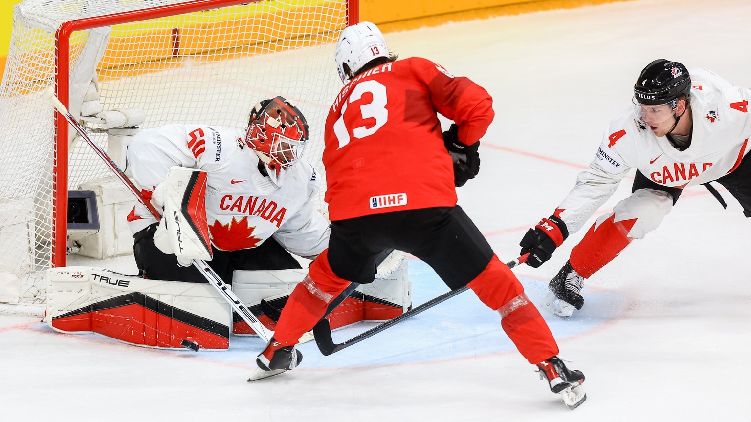 epa11369052 Nico Hischier of Switzerland (C) in action against goalkeeper Jordan Binnigton of Canada (L) during the IIHF Ice Hockey World Championship 2024 semi-finals match between Canada and Switzer ...