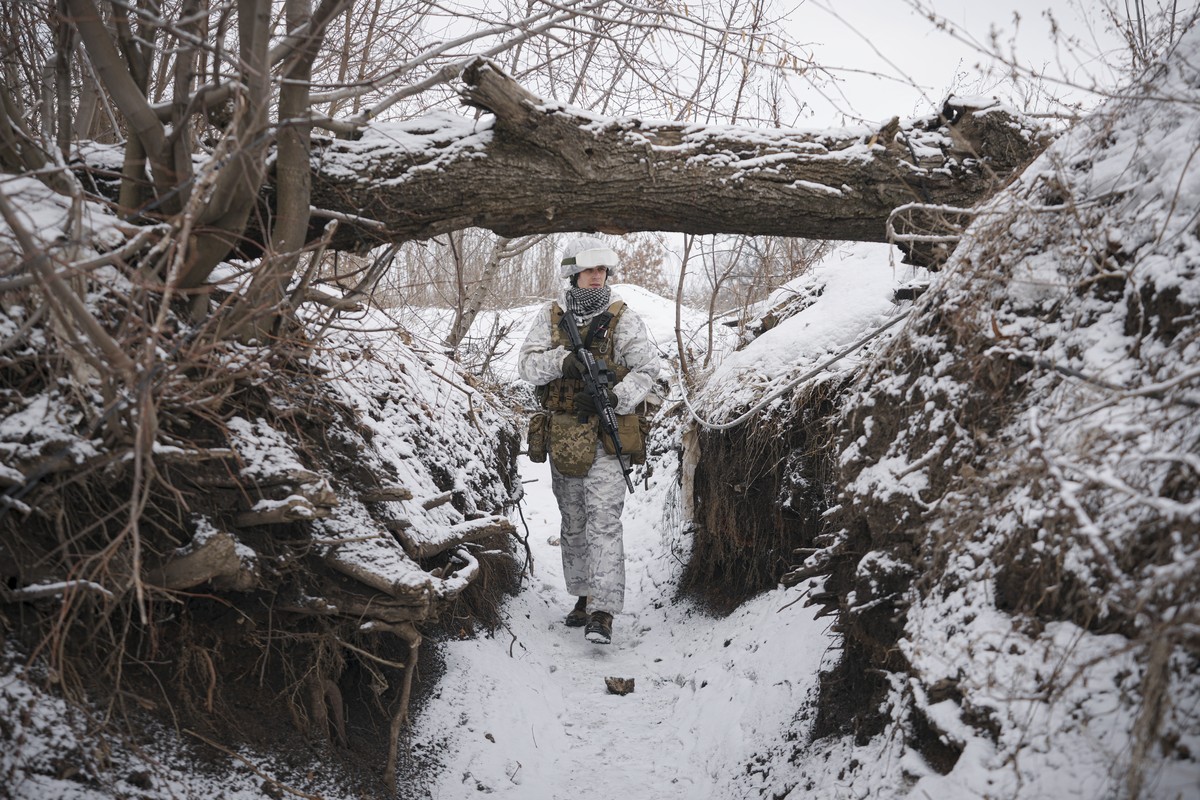 A Ukrainian serviceman patrols along a frontline position outside Avdiivka, Donetsk region, eastern Ukraine, Saturday, Feb. 5, 2022. The French president and the German chancellor will head to Moscow  ...
