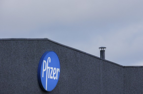 A general view of the signage at Pfizer Manufacturing plant in Puurs, Belgium, on Friday, Dec. 4, 2020. British officials on Wednesday authorized a COVID-19 vaccine for emergency use, greenlighting th ...