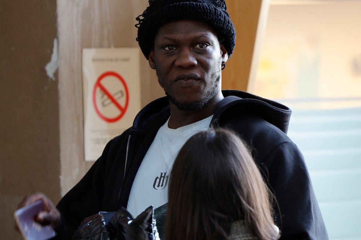 French rapper Doums, also known as Mamadou Coulibaly, arrives for his trial for violence against his partner at the Creteil courthouse, a suburb east of Paris, on February 2, 2026. (Photo by GEOFFROY  ...
