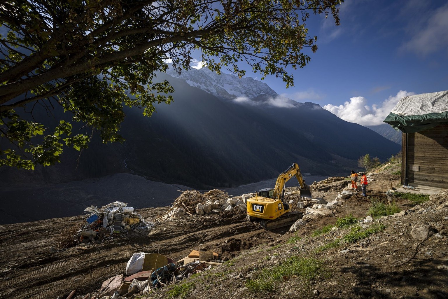Workers sort material from destroyed houses in the damaged hamlet of Weissenried, 4 months after a landslide destroyed the village, in Blatten, Switzerland, on Wednesday, October 1, 2025. On May 28, 2 ...
