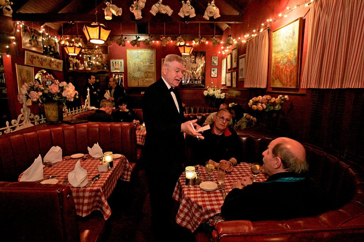 WEST HOLLYWOOD, CA  MARCH 7, 2009  Waiter Vladimir Bezak interacting with customers Lee Mlejnek, cq, 62, RT, of San Francisco, and Edward Buliavac, cq, 64, of La Ca-ada, at Dan Tana's restauran ...