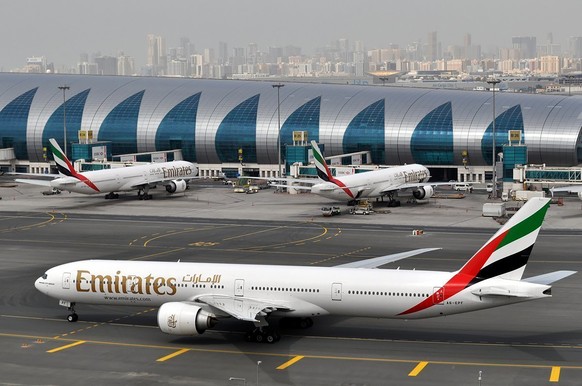 FILE - An Emirates plane taxis to a gate at Dubai International Airport at Dubai International Airport in Dubai, United Arab Emirates, March 22, 2017. (AP Photo/Adam Schreck, File)