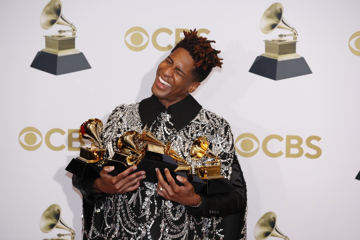epa09869503 Jon Batiste poses in the press room with his Grammys for Best American Roots Song 'Cry', Best American Roots Performance 'Cry', for Best Music Video 'Freedom' ...