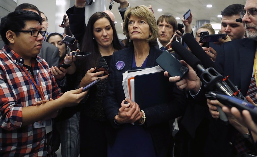 Sen. Lisa Murkowski, R-Alaska, walks with reporters as in the basement of the U.S. Capitol in Washington, Thursday, Jan. 30, 2020, while leaving at the end of a session in the impeachment trial of Pre ...