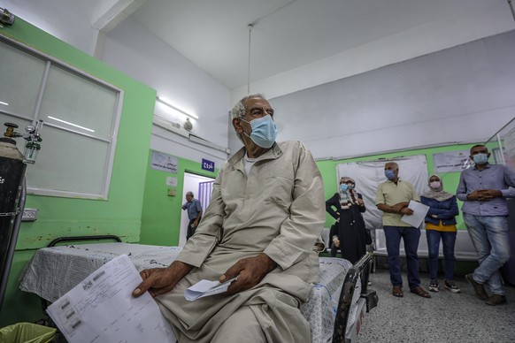 epa09419761 Palestinians wearing protective face masks suffering symptoms of coronavirus wait to get a COVID-19 swab test, at Al-Shifa hospital in Gaza City, 18 August 2021. According to the Palestini ...