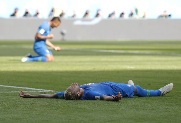 Brazil&#039;s Neymar lies on the pitch the in the penalty area during the group E match between Brazil and Costa Rica at the 2018 soccer World Cup in the St. Petersburg Stadium in St. Petersburg, Russ ...