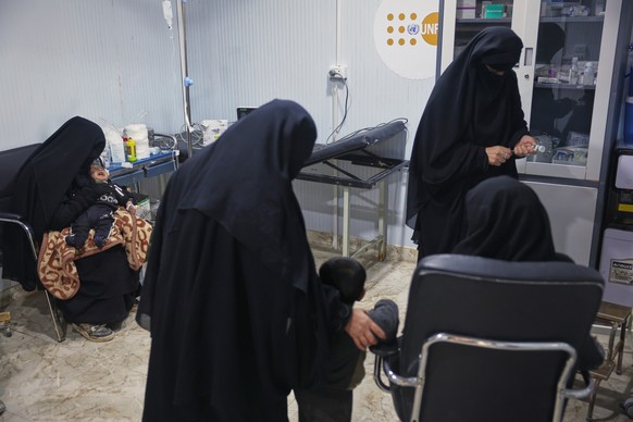 Women receive medication and treatment for their children at a medical center in the al-Hol camp, one of the detention facilities holding thousands of Islamic State group members and their families, n ...