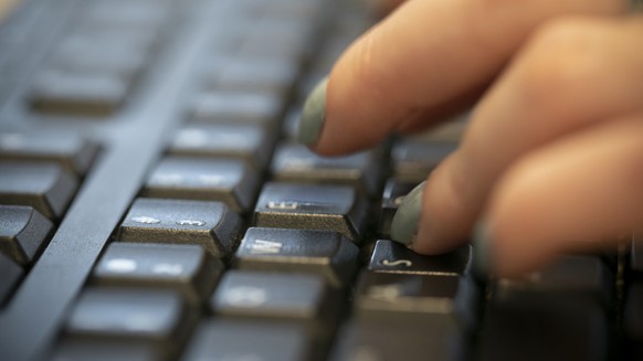 FILE - In this Oct. 8, 2019, file photo a woman types on a keyboard in New York. Phishing scams that infect a computer and potentially allow hackers to invade bank and other accounts are highly preven ...