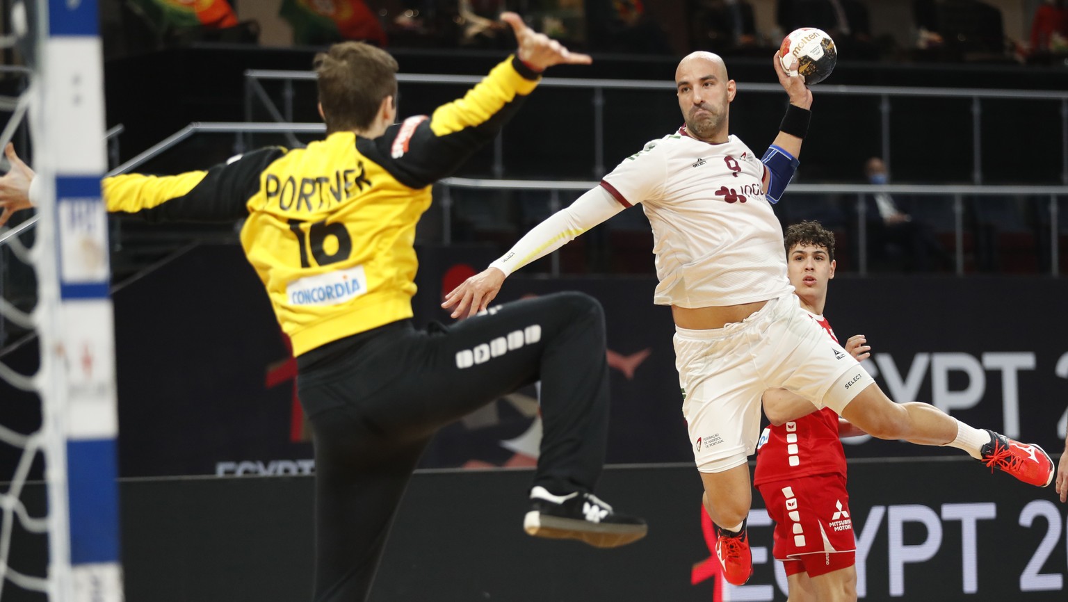 Portugal&#039;s Joao Ferraztakes a shoot as Switzerland&#039;s goal keeper Nikola Portner in action during the World Handball Championship between Switzerland and Portugal in Cairo, Egypt, Friday, Jan ...
