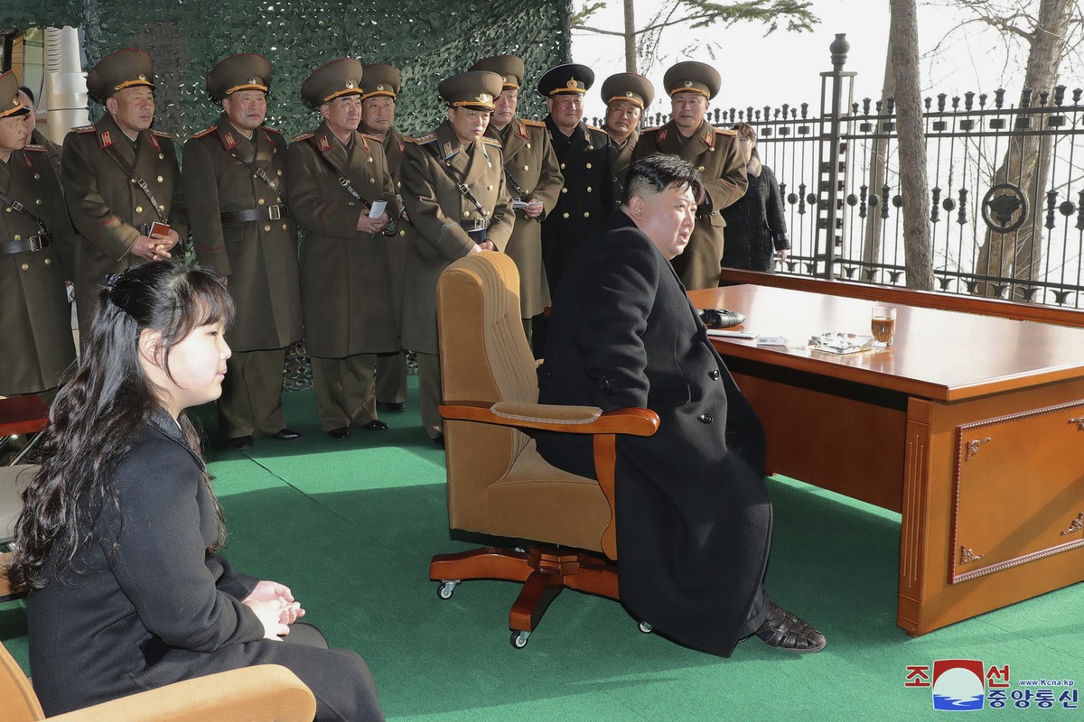 In this photo provided by the North Korean government, North Korean leader Kim Jong Un, with his daughter, inspects what it says is an artillery drill at an undisclosed location in North Korea, Thursd ...