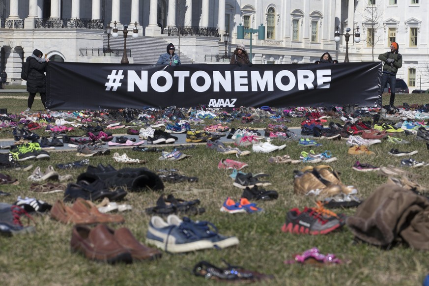 epa06601077 Approximately seven thousand shoes representing lost children to guns since the 14 December 2012 shooting at Sandy Hook Elementary School in Newtown, Connecticut, are seen on the East Fron ...