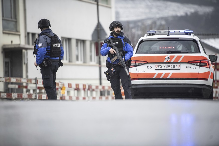 Police at the scene after a shooting incident, in Sion, Switzerland, Monday, Dec. 11, 2023. Police say two people have been killed and one wounded after a gunman fired shots at two locations in a sout ...