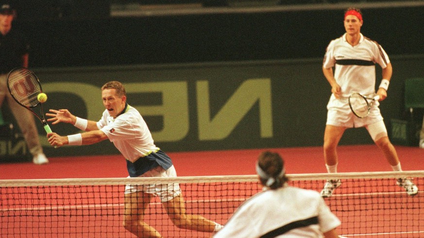 Swedish Jonas Bjorkman, left, at the ball with Nicklas Kulti to the right during the double match against Italy in the Davis Cup semifinal in Norrkoping, Sweden, Saturday September 20 1997. Italian Di ...