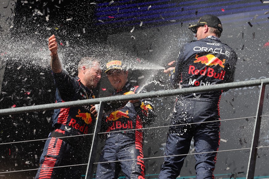 epa10777541 (L-R) Greg Reeson, Technician of Red Bull Racing, Second placed Mexican Formula One driver Sergio Perez of Red Bull Racing and first winner Dutch Formula One driver Max Verstappen of Red B ...