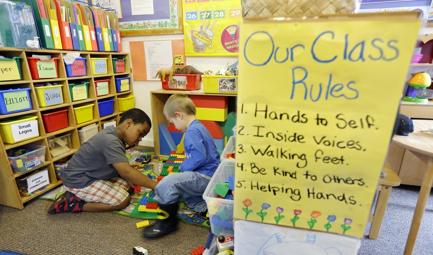 Isaiah Simanton, 5, left, and Elliott Hill, 4, right, play with Legos next to a poster of class rules in a Pre-Kindergarten class at the Community Day Center for Children, during class Tuesday, Oct. 2 ...