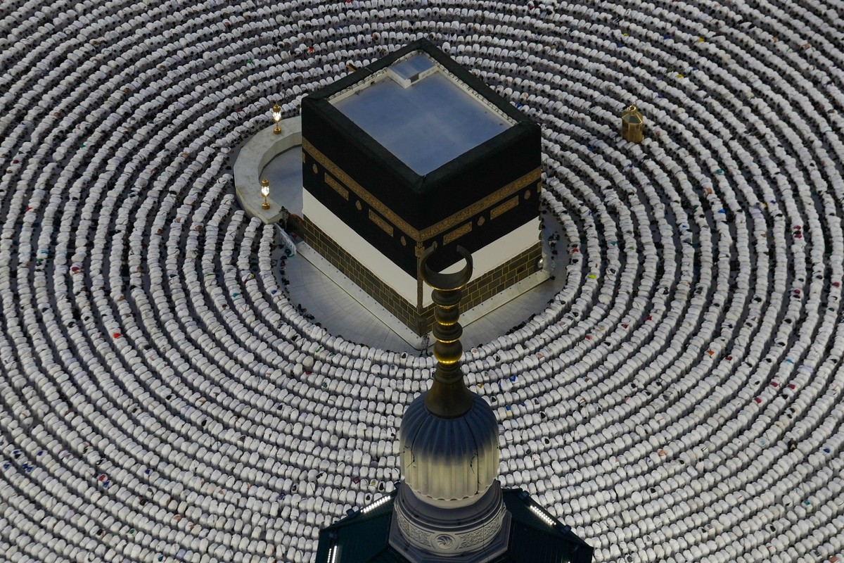 Muslim pilgrims prostrate as they offer evening prayers around the Kaaba, Islam's holiest site in the holy city of Mecca during the annual hajj pilgrimage, Saudi Arabia, Sunday, May 24, 2026. (AP ...