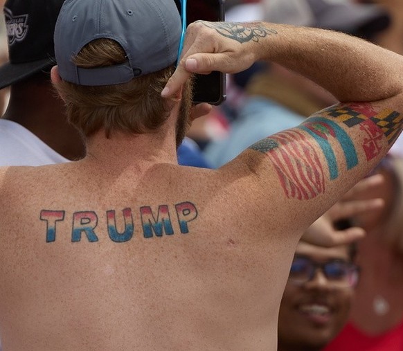 epa11401222 A man shows off his Trump tattoo during an election rally for Republican presidential candidate and former President Donald Trump at Sunset Park in Las Vegas, Nevada, USA, 09 June 2024. EP ...
