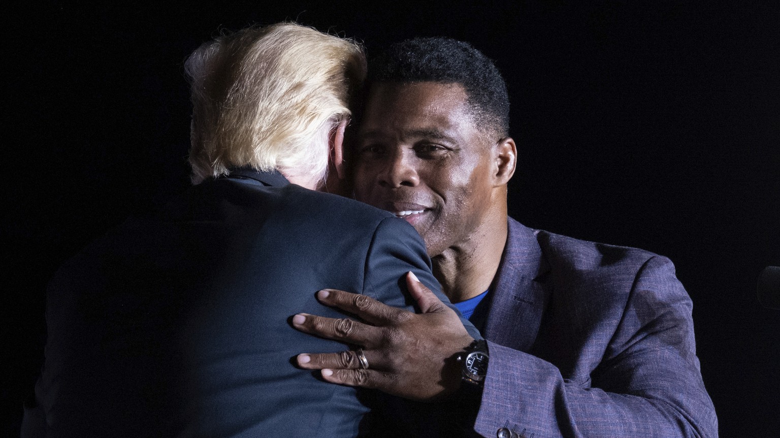 Former President Donald Trump hugs Georgia Senate candidate Herschel Walker during his Save America rally in Perry, Ga., on Saturday, Sept. 25, 2021. (AP Photo/Ben Gray)