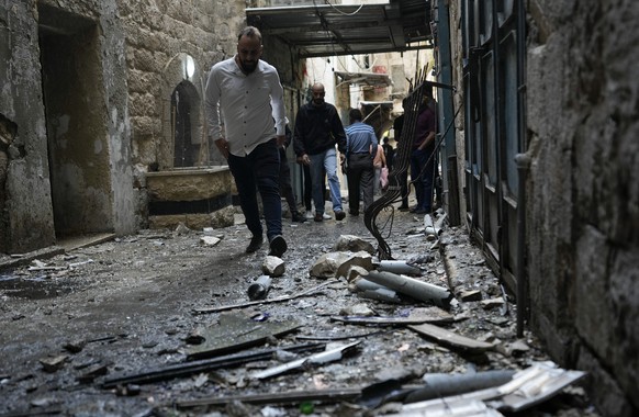 Palestinians gather at the site where Israeli forces destroyed an explosive lab belonging an armed group calling itself the Lions&#039; Den, in the occupied West Bank city of Nablus, Tuesday, Oct. 25, ...