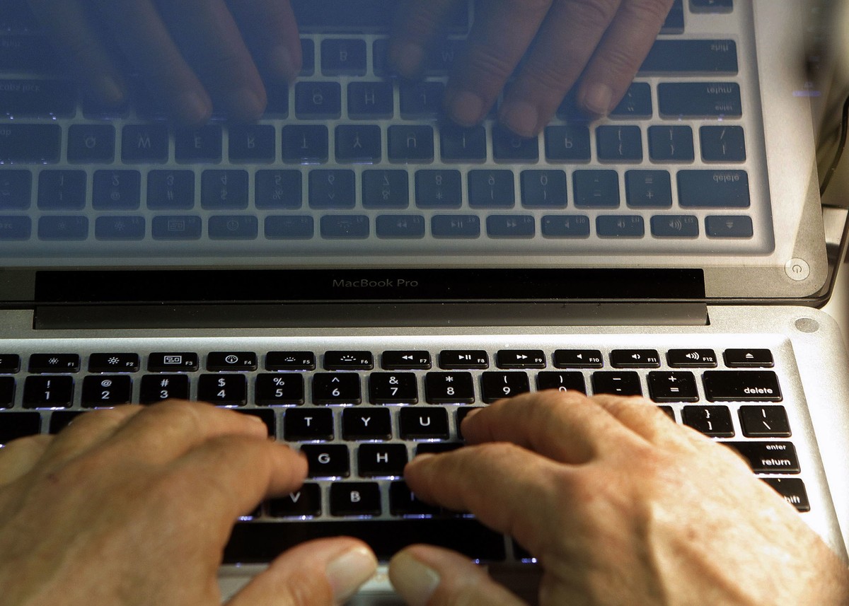 FILE - In this Feb. 27, 2013, file photo illustration, hands type on a computer keyboard in Los Angeles. Spring is a great time to clear out your digital clutter and make sure that you're adequat ...