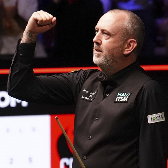 Wales&#039; Mark Williams celebrates winning his game against Scotland&#039;s John Higgins on day twelve of the Halo World Snooker Championship at the Crucible Theatre in Sheffield, England, Wednesday ...