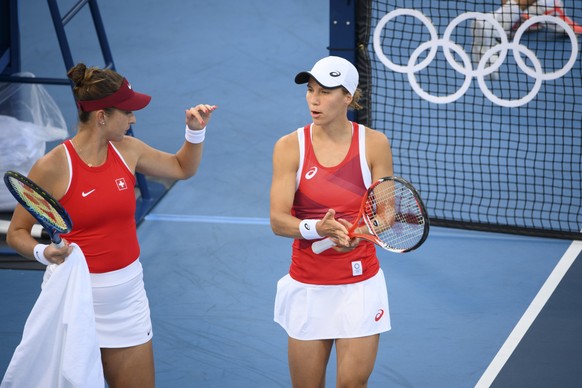 Belinda Bencic, left, and Viktorija Golubic, right, of Switzerland talk together during the game against Carla Suarez Navarro and Garbine Muguruza of Spain during the women&#039;s doubles tennis secon ...